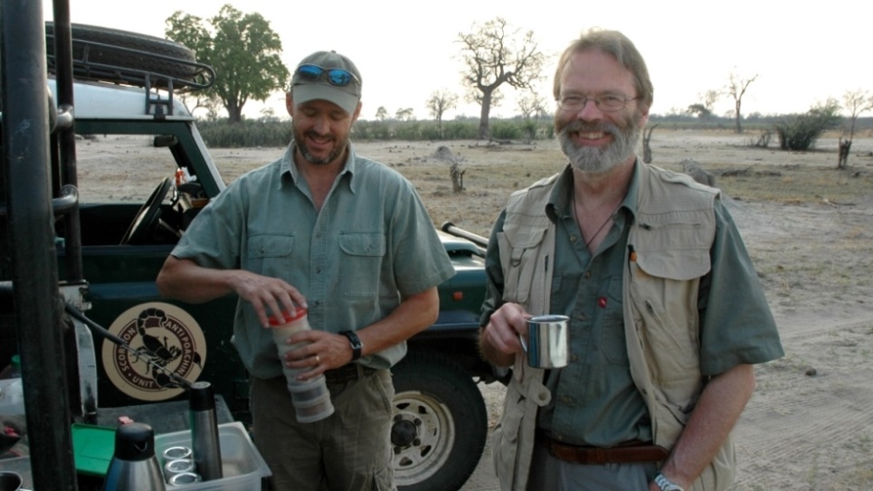 David Macdonald (right) taking a break from wildlife tracking. Photo credit: WildCRU
