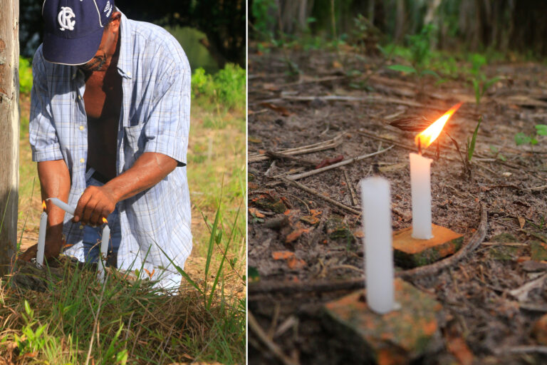 Raimundo Serrão lights candles for their departed family members.